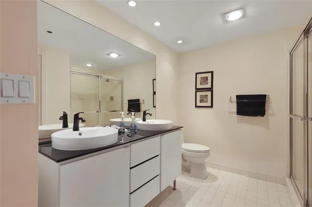 a bathroom with a sink toilet and a mirror