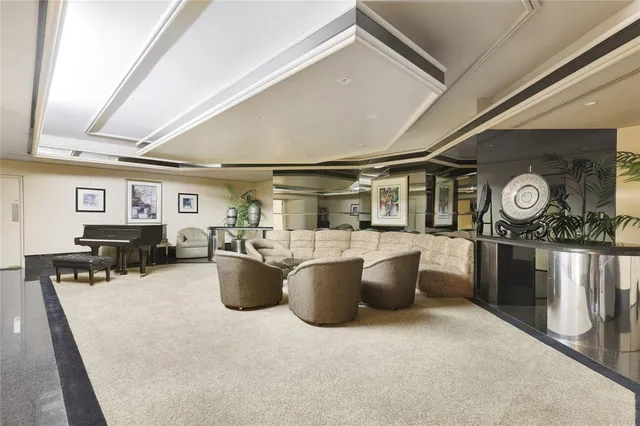 a living room with couches and kitchen view