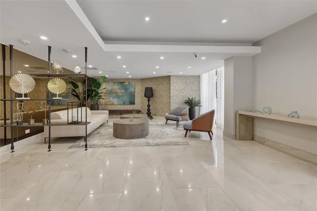 a lobby with furniture and a large mirror