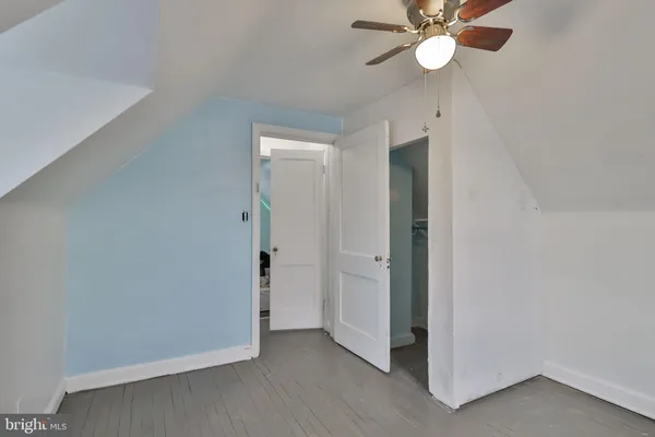 a bedroom with a bed and a desk