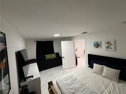 a bedroom with a bed and couch