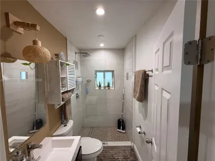 a bathroom with a toilet a sink and shower
