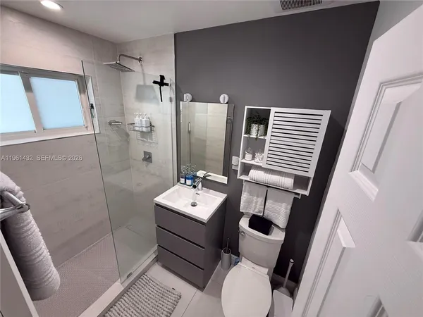 a bathroom with a sink toilet and shower