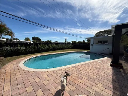 a view of a swimming pool with a yard