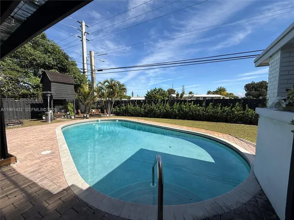 a view of a swimming pool with a lounge chairs