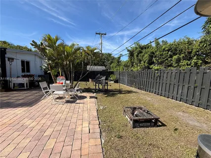 a view of a backyard with sitting area