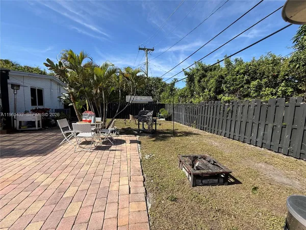 a view of a backyard with sitting area
