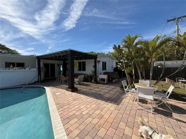 a view of a backyard with sitting area
