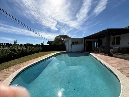 a view of a backyard with sitting area