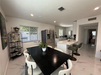 a dining room with furniture and window
