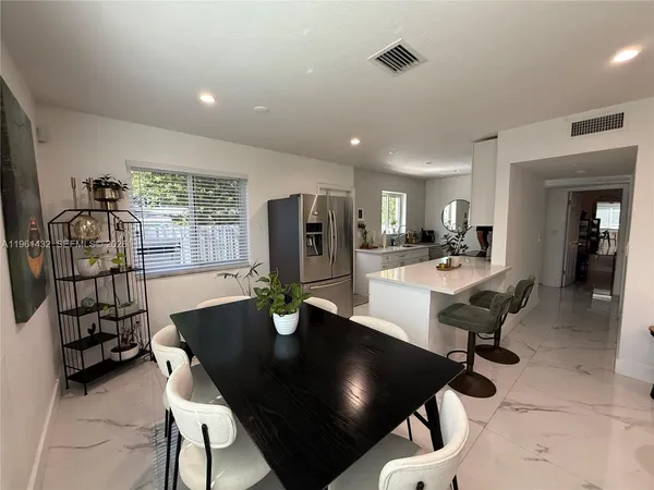 a dining room with furniture and window