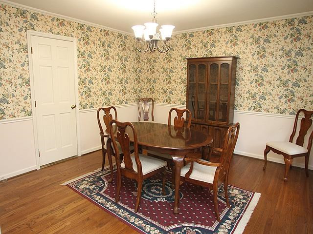 1104 Country Ridge Drive Raleigh, NC 27609 - Photo 6 of 24 Formal Dining Room Features Hardwood Floors and Updated Light Fixture Dining Room