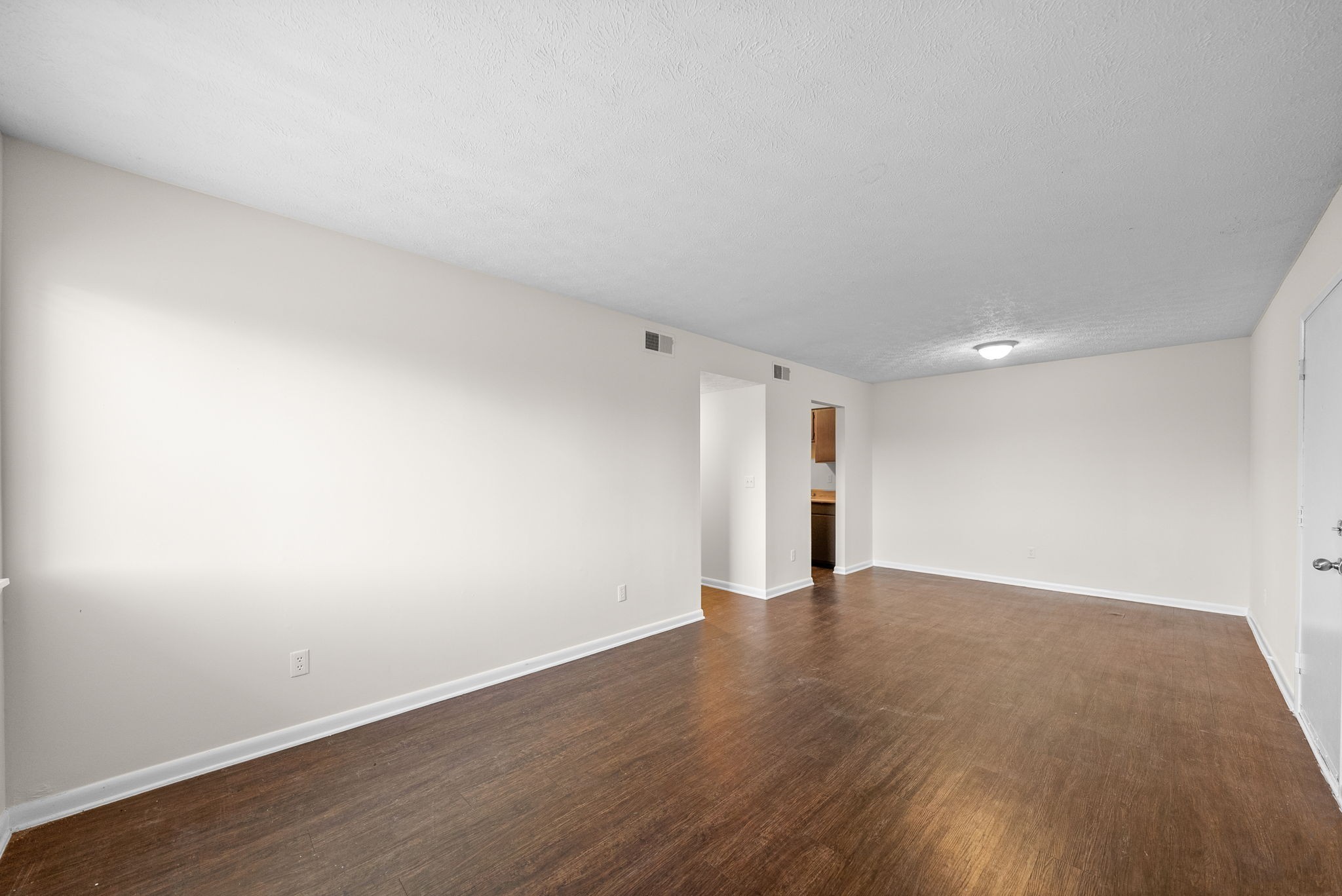 225 Clara Drive, Unit 2B Pembroke, KY 42266 - Photo 3 of 12 a view of an empty room with wooden floor and a window
