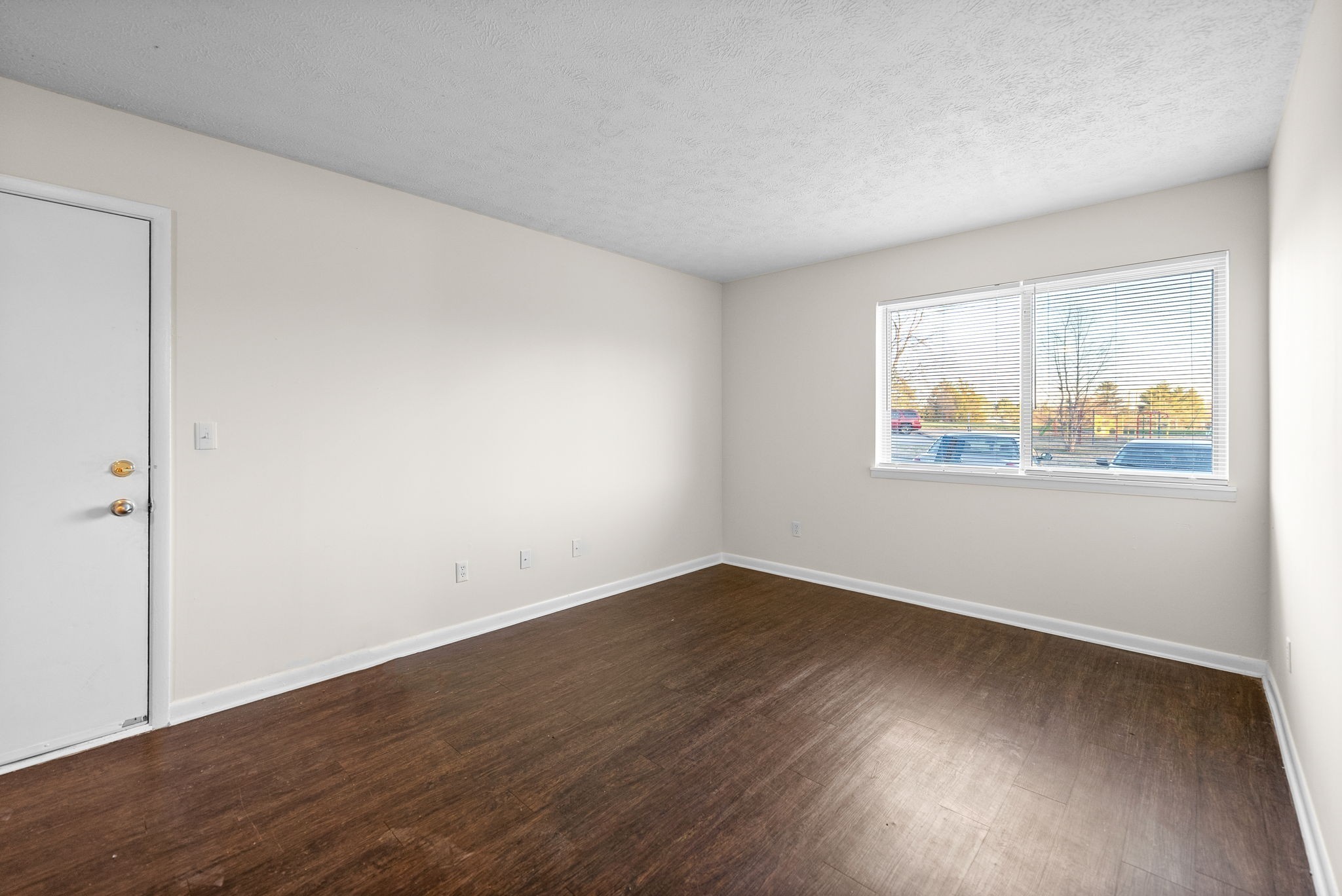 225 Clara Drive, Unit 2B Pembroke, KY 42266 - Photo 5 of 12 an empty room with wooden floor and windows