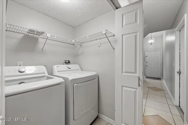 a view of a backyard with wooden fence and large trees