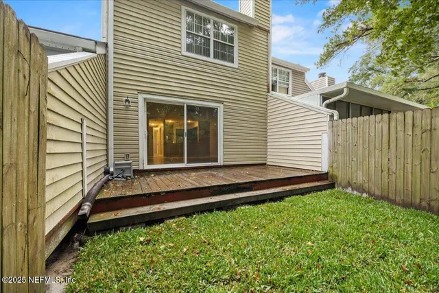 a view of a backyard with a tree
