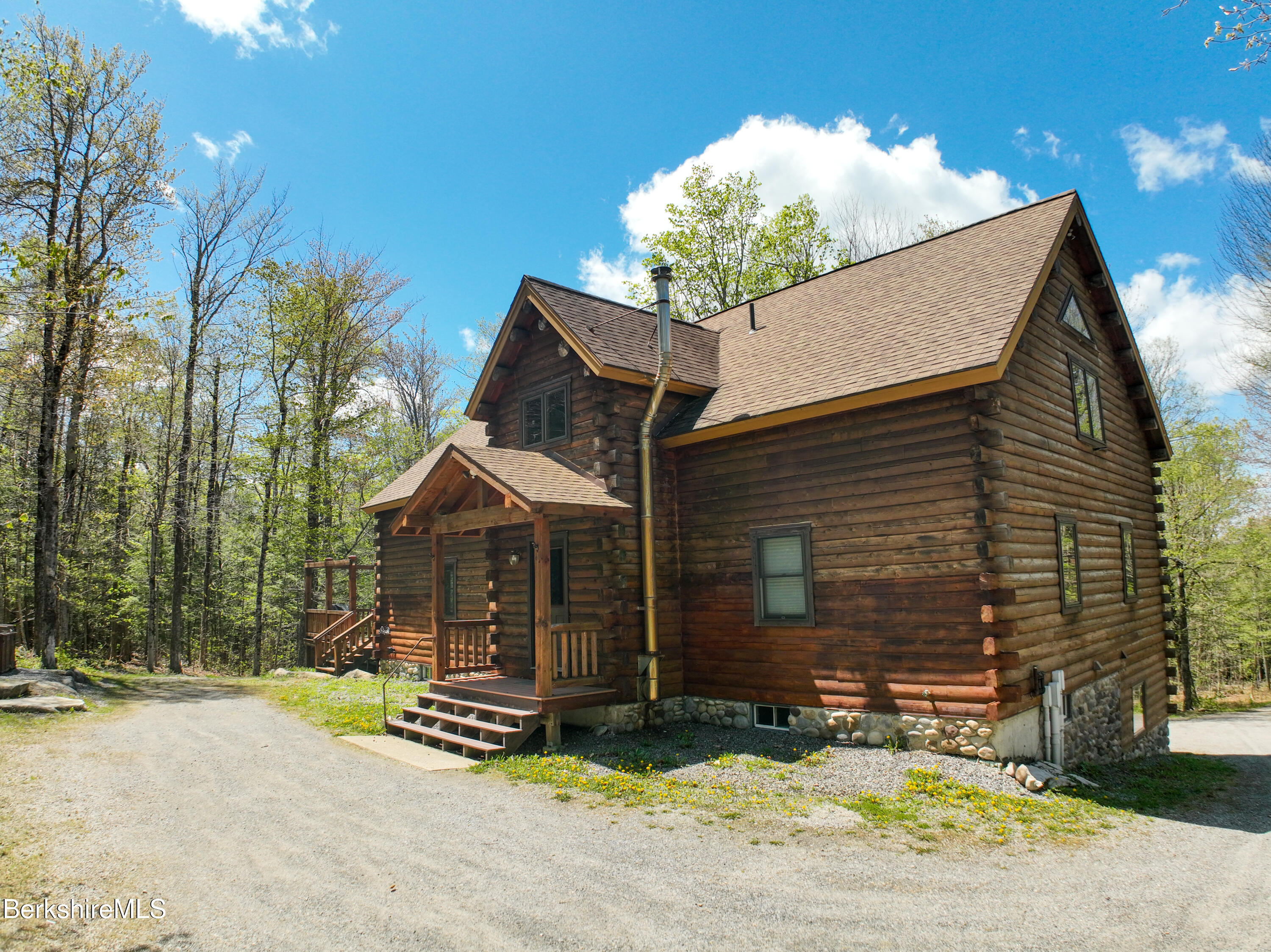 233 Algerie Road Becket, MA 01223 - Photo 43 of 48 a front view of a house with a yard