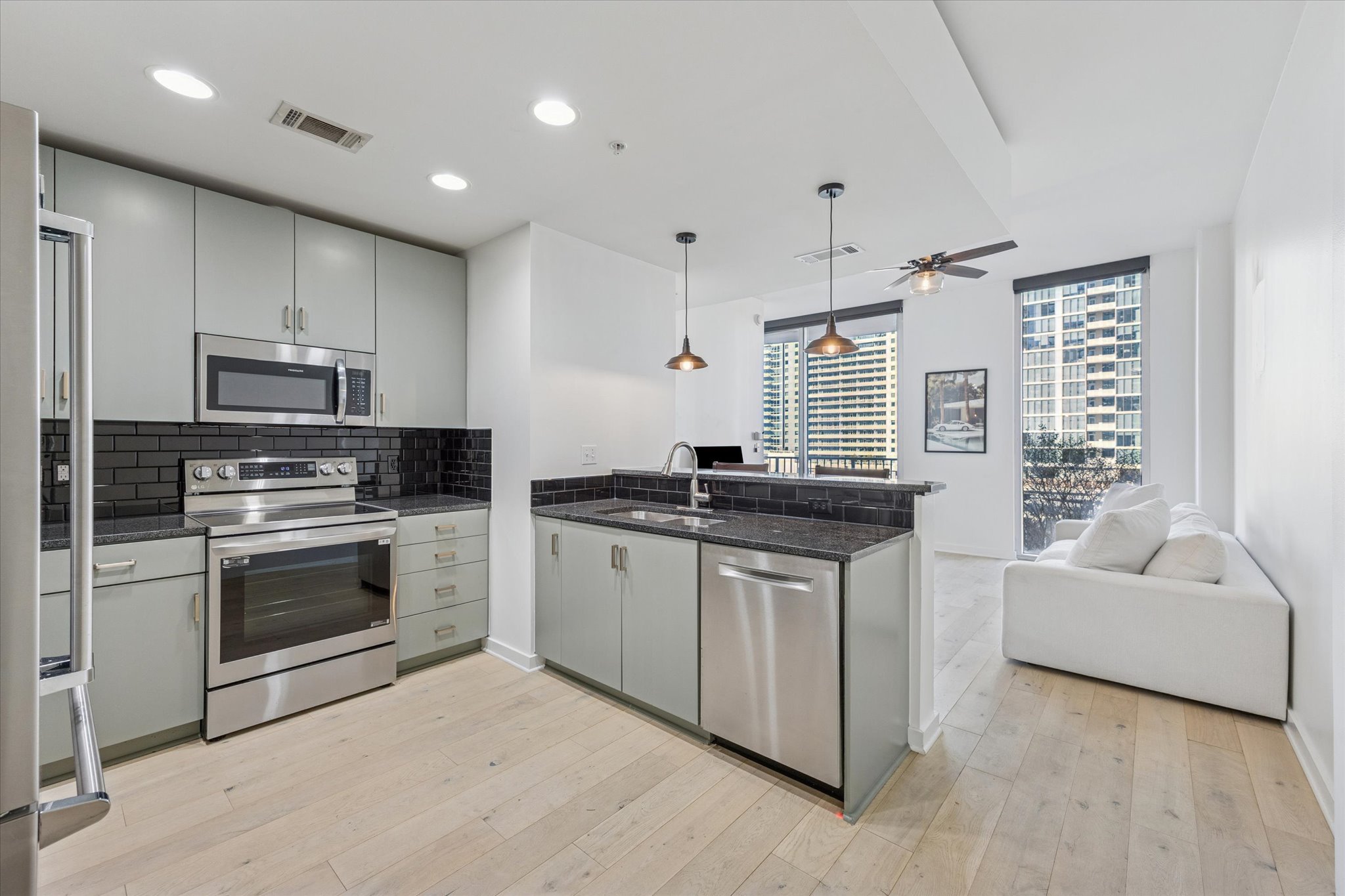 360 Nueces Street, Unit 1108 Austin, TX 78701 - Photo 31 of 31 a kitchen with stainless steel appliances granite countertop a stove a sink and a refrigerator