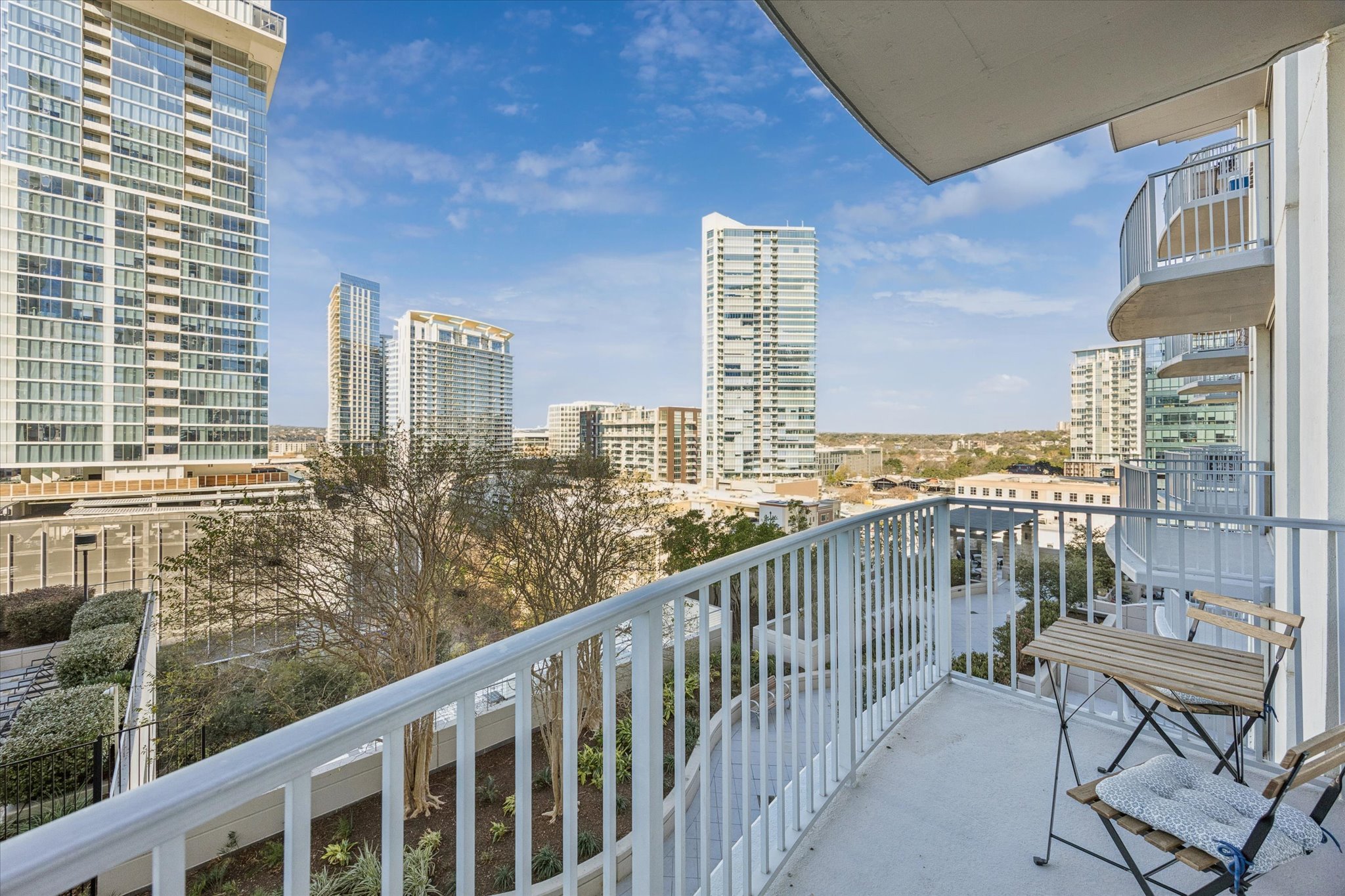 360 Nueces Street, Unit 1108 Austin, TX 78701 - Photo 13 of 31 a view of a balcony with wooden chairs
