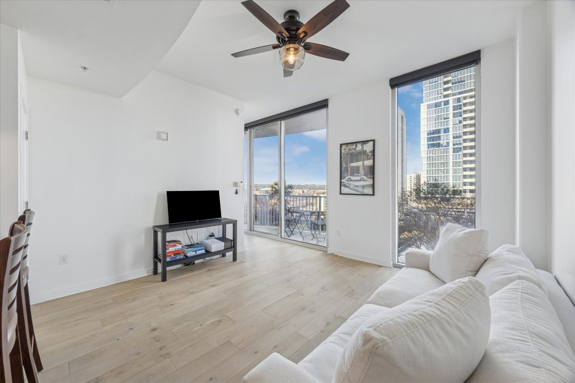 360 Nueces Street, Unit 1108 Austin, TX 78701 - Photo 6 of 31 a living room with furniture and a flat screen tv