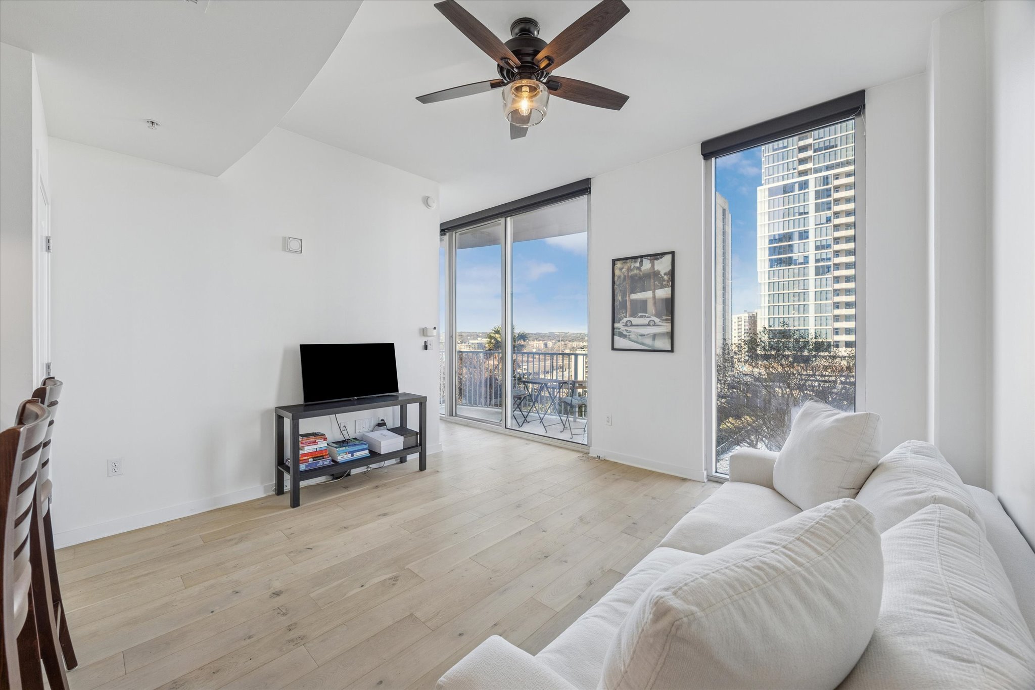 360 Nueces Street, Unit 1108 Austin, TX 78701 - Photo 6 of 31 a living room with furniture and a flat screen tv