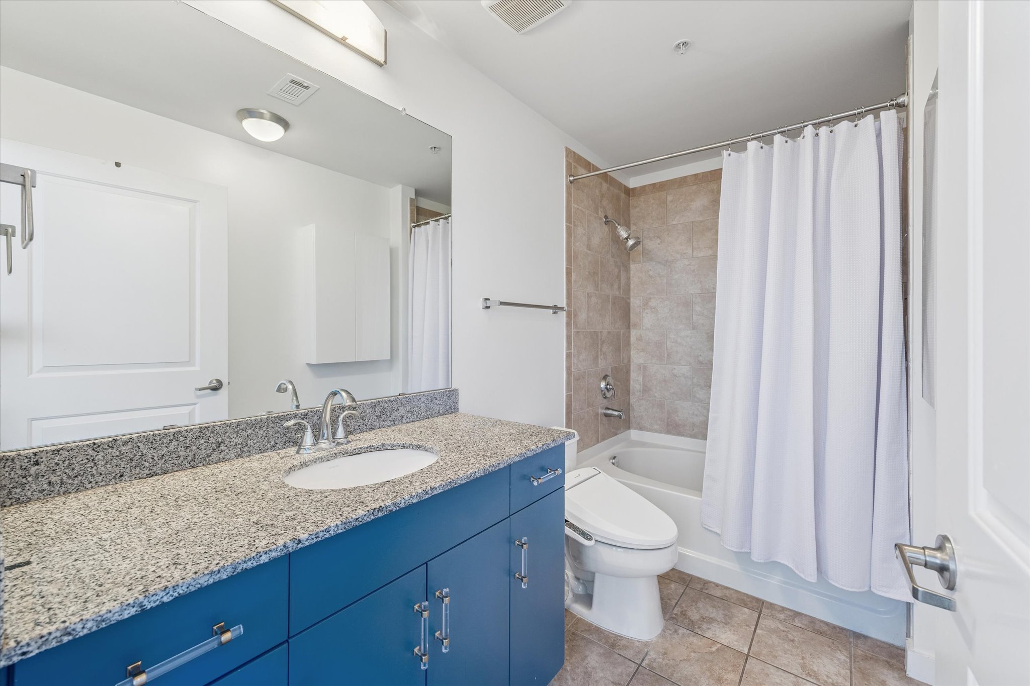 360 Nueces Street, Unit 1108 Austin, TX 78701 - Photo 7 of 31 a bathroom with a granite countertop sink toilet and shower