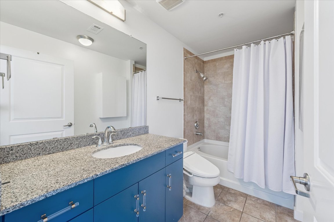 360 Nueces Street, Unit 1108 Austin, TX 78701 - Photo 7 of 31 a bathroom with a granite countertop sink toilet and shower