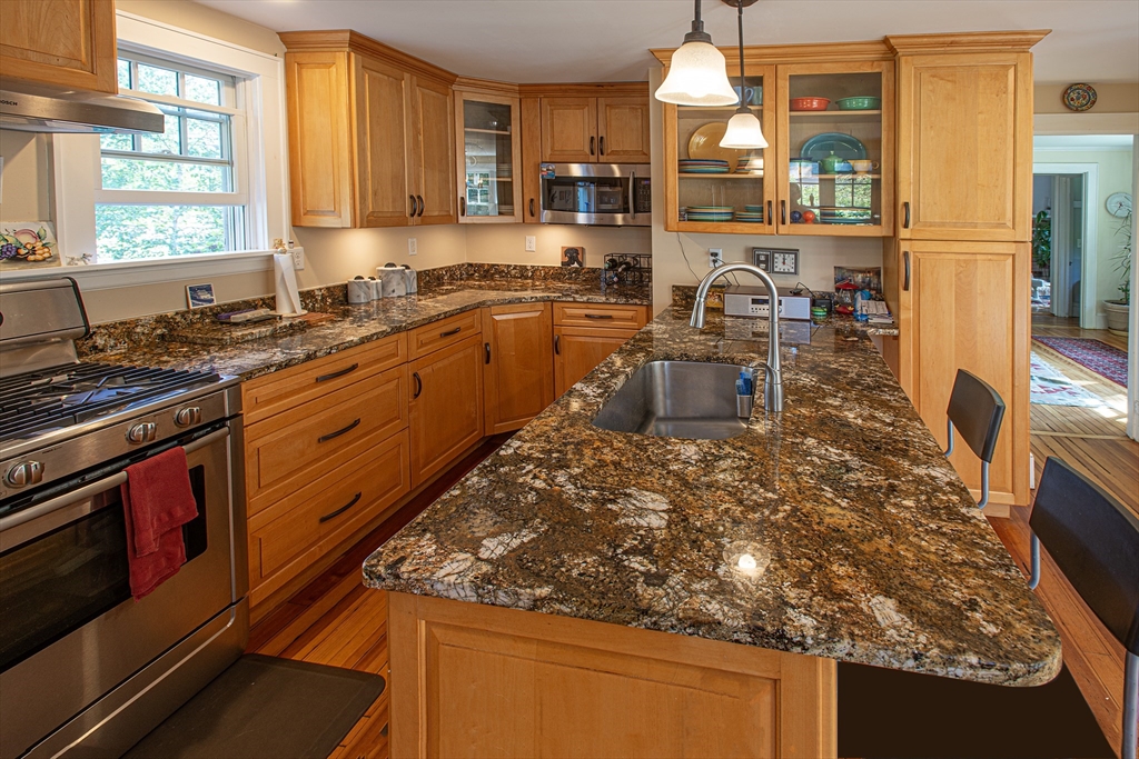 218 Elm Street Northampton, MA 01060 - Photo 14 of 42 a kitchen with stainless steel appliances granite countertop a stove a sink and a microwave