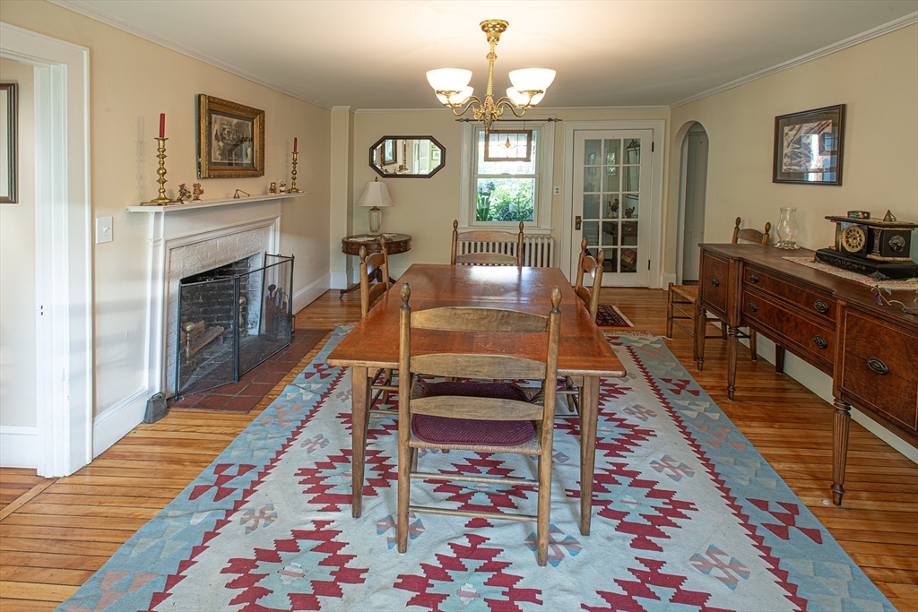 218 Elm Street Northampton, MA 01060 - Photo 16 of 42 a living room with dining area a rug and a fireplace