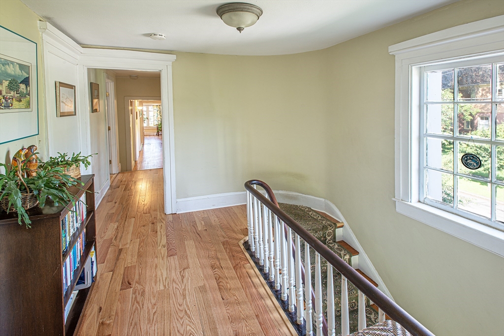 218 Elm Street Northampton, MA 01060 - Photo 30 of 42 a view of a hallway with wooden floor and windows