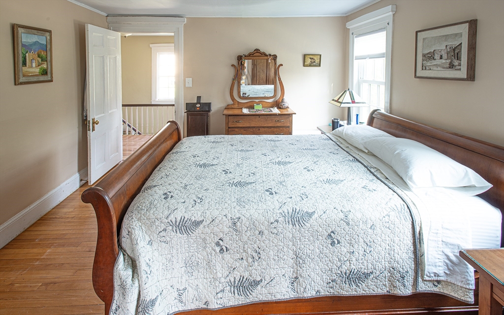 218 Elm Street Northampton, MA 01060 - Photo 31 of 42 a bedroom with a bed and wooden floor
