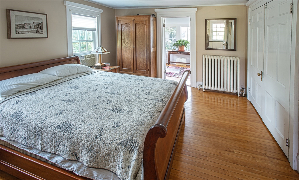 218 Elm Street Northampton, MA 01060 - Photo 32 of 42 a bedroom with a bed and wooden floor