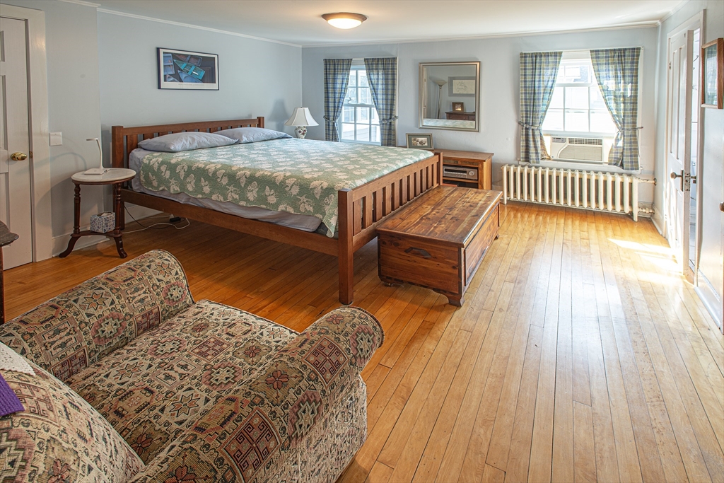 218 Elm Street Northampton, MA 01060 - Photo 35 of 42 a bedroom with a bed and wooden floor