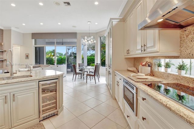 a dining room with furniture a chandelier and a rug