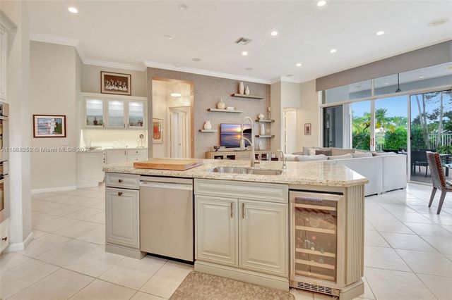 a large white kitchen with cabinets a sink and a counter top space