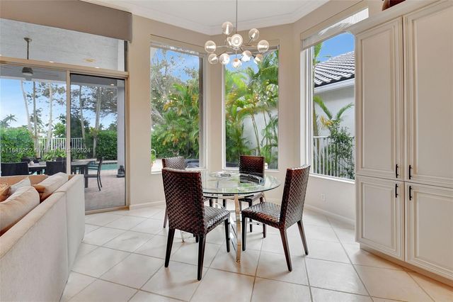 a dining hall view with a large dining table and a large window