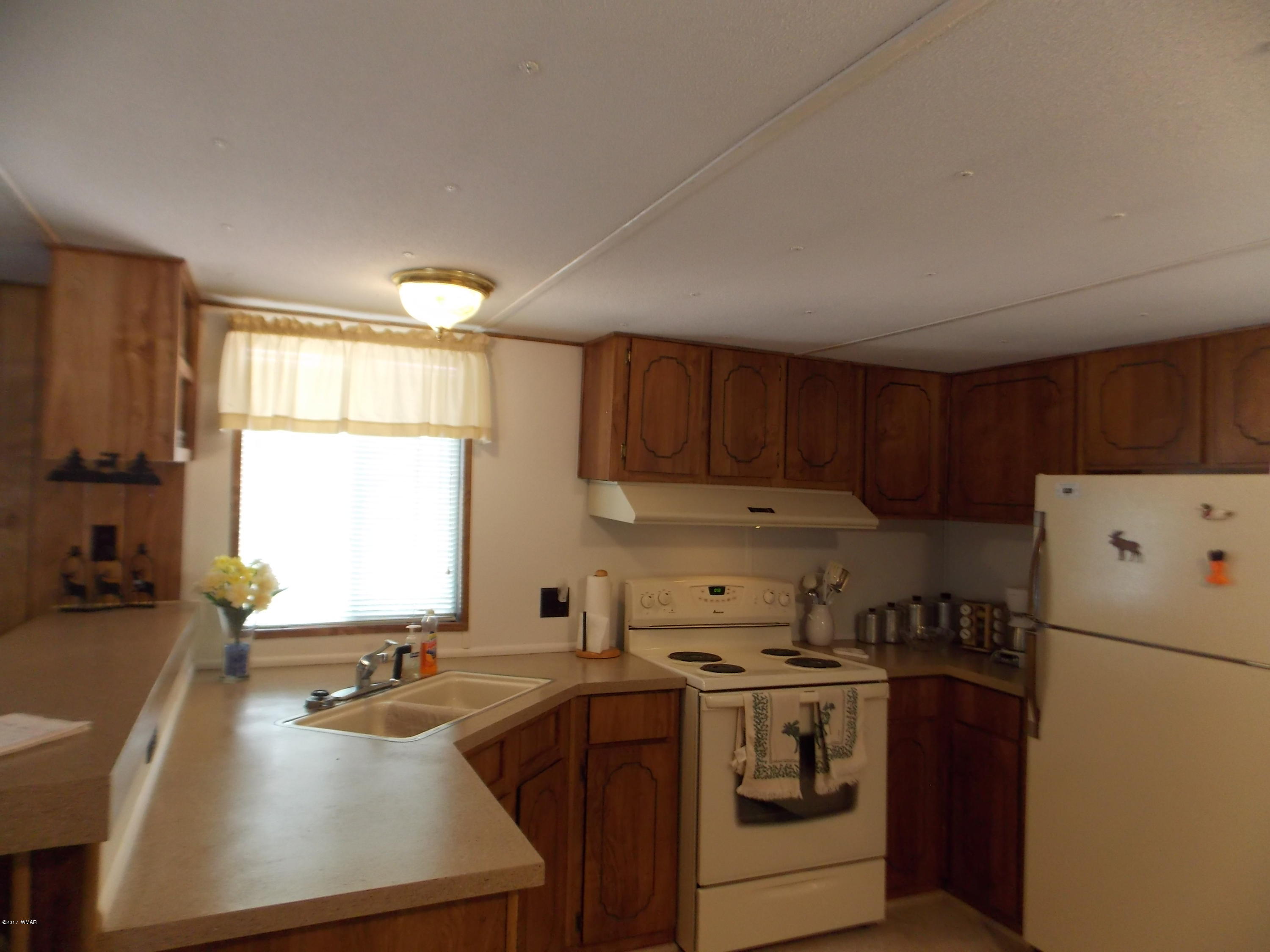 1978 Rustling Pine Drive Heber, AZ 85928 - Photo 5 of 21 a kitchen with a sink a stove a refrigerator and a window