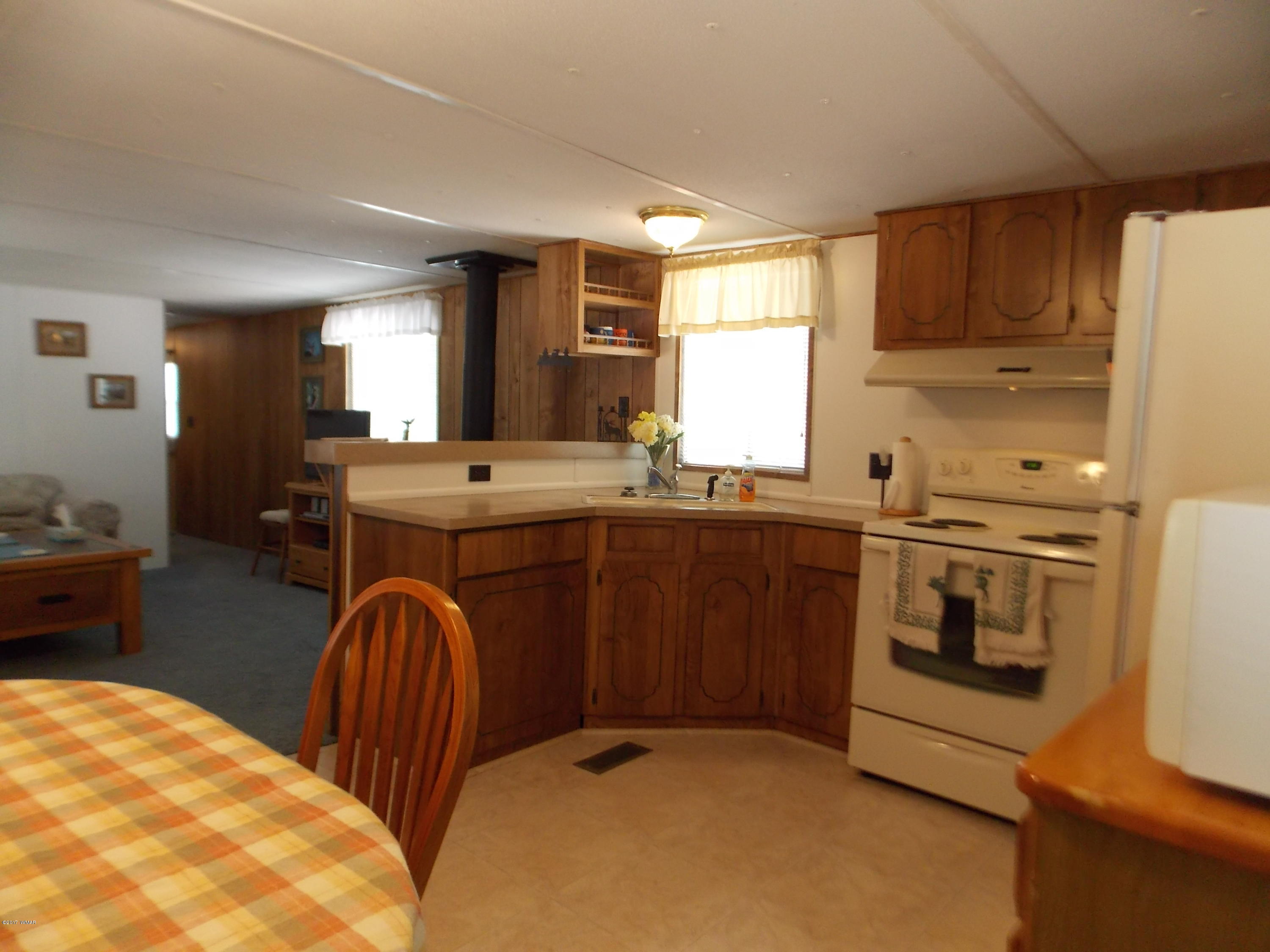 1978 Rustling Pine Drive Heber, AZ 85928 - Photo 6 of 21 a kitchen with stainless steel appliances granite countertop a stove a sink and a microwave