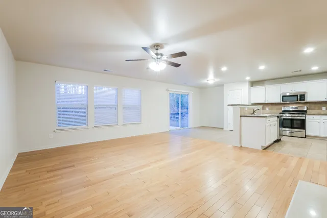 a view of an empty room with a kitchen