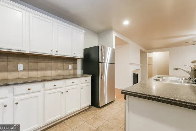 a kitchen with stainless steel appliances granite countertop a refrigerator sink and cabinets