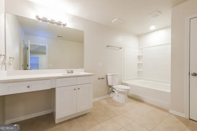 a bathroom with a toilet sink and a mirror