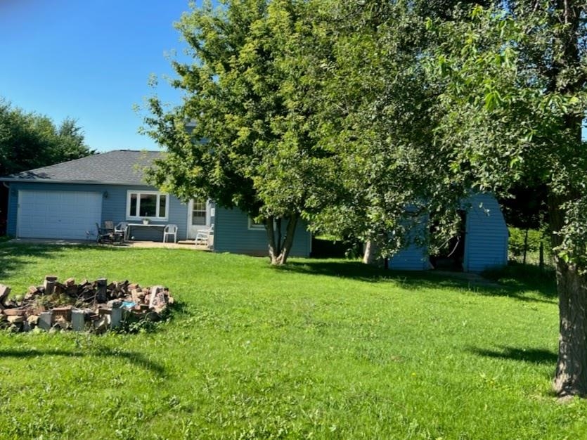 5773 East Brick Road Oregon, IL 61061 - Photo 2 of 7 a view of a house with a backyard