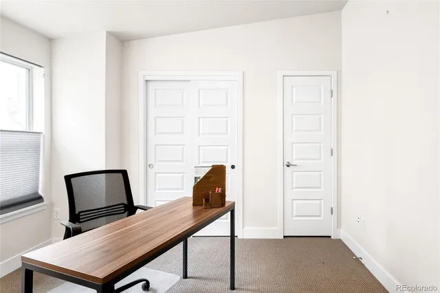 a view of a workspace with furniture