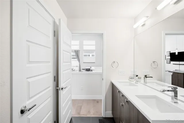 a bathroom with a double vanity sink a mirror and a