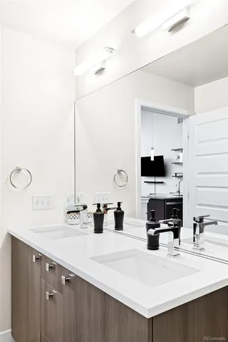 a kitchen with a sink a counter and a refrigerator