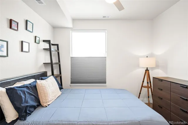 a bedroom with a bed and a lamp