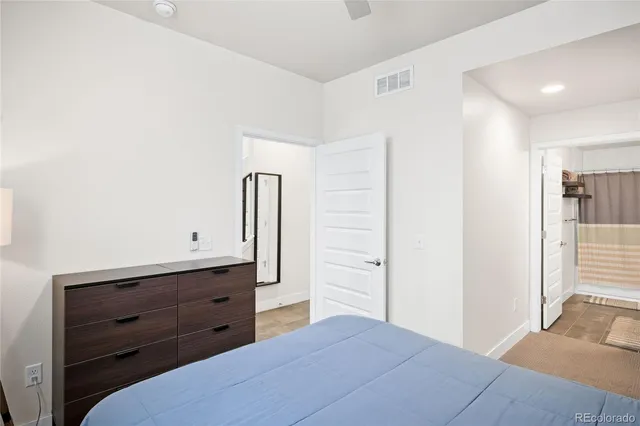 a bedroom with a bed and a dresser