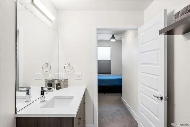 a en suite bathroom with a sink and a mirror