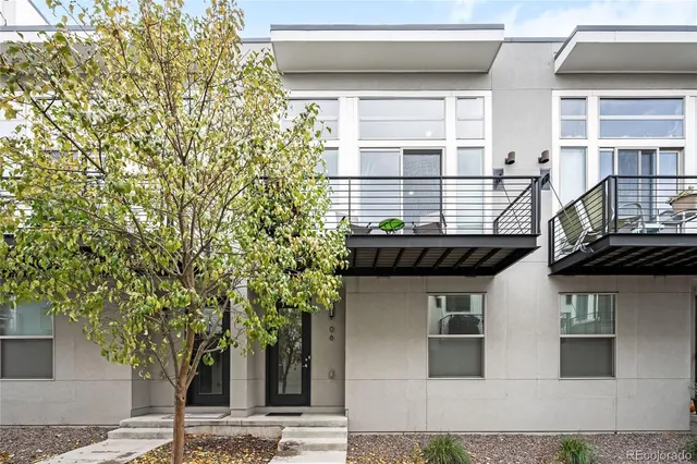front view of a house with a tree