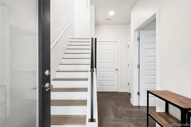 a view of a hallway with wooden floor and entryway